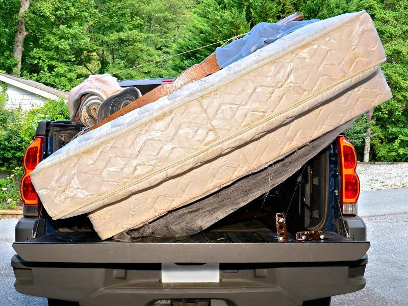 Pickup truck hauling old mattresses