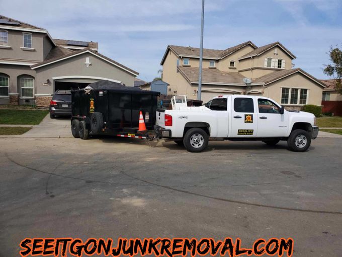 White pickup truck with black dump trailer